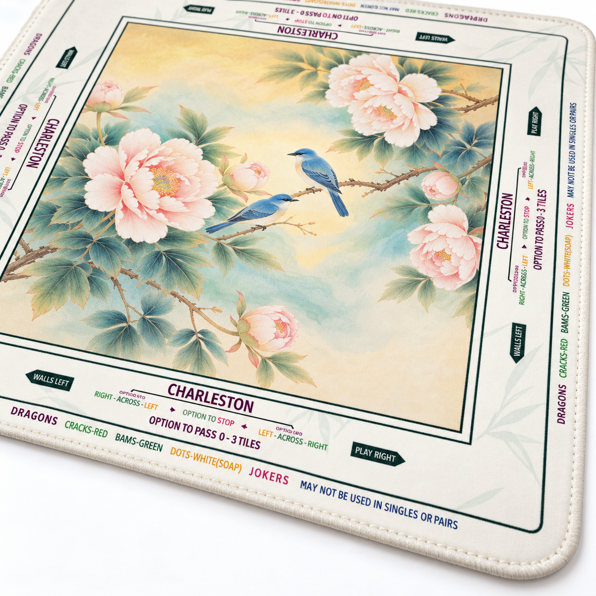 Close-up of Bird of Paradise mahjong mat fabric and matching ivory stitched edge