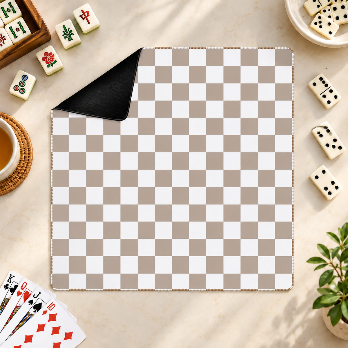 Checker mocha mahjong mat with mahjong tiles, playing cards and dominoes as props outside the mat