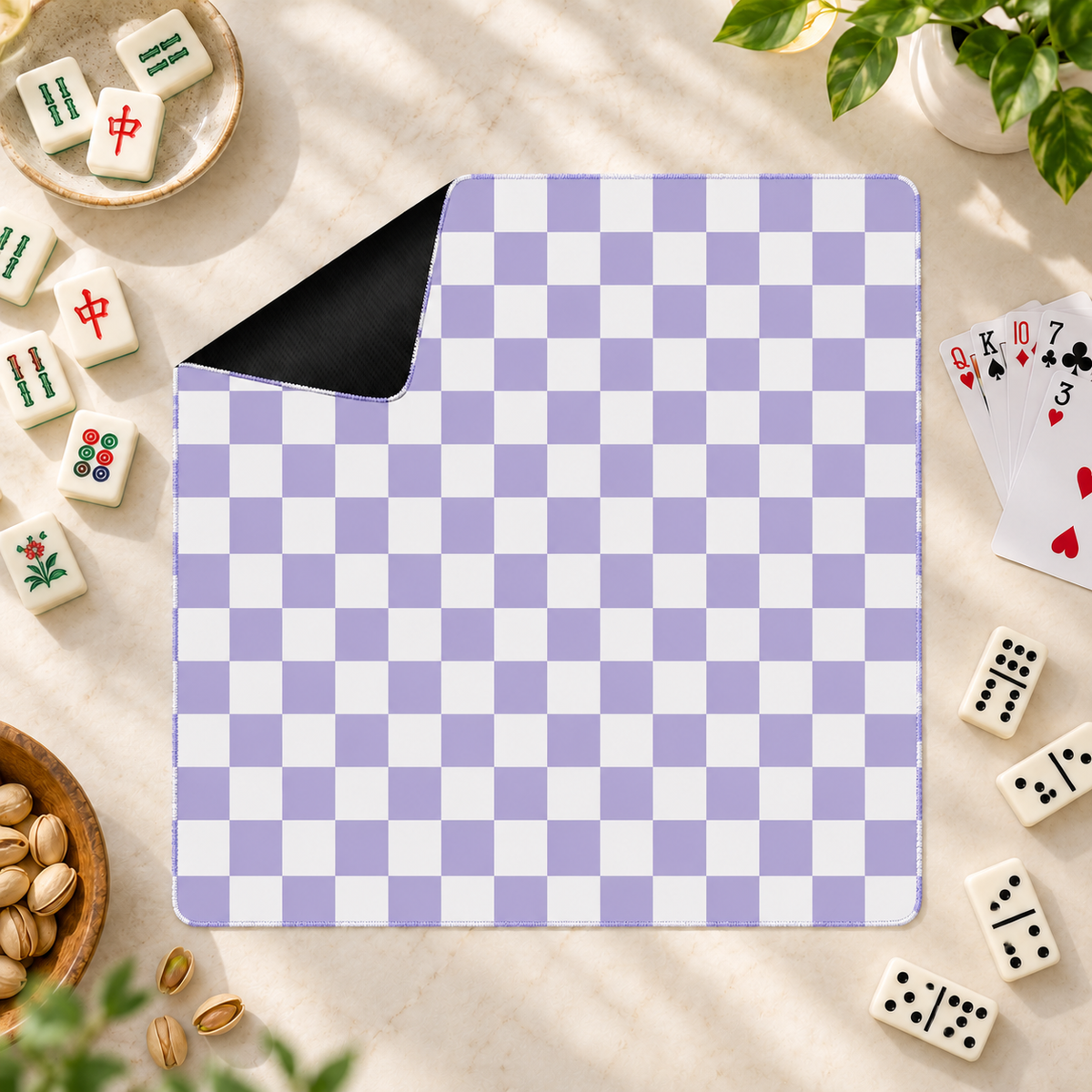Checker purple mahjong mat with mahjong tiles, playing cards and dominoes as props outside the mat