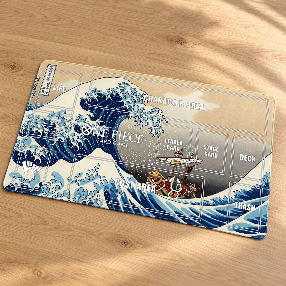 Angled tabletop view of Great Wave Thousand Sunny One Piece zoned playmat